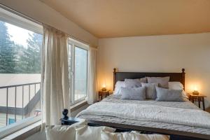 a bedroom with a bed and a large window at Brian Head Studio Condo with Balcony and Mountain View in Brian Head