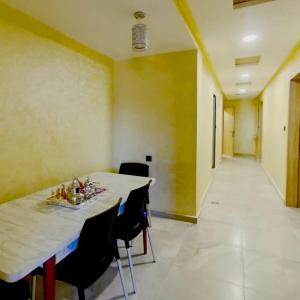 a room with a table and chairs and a hallway at KHALIJ HOSPITALITE in Dakhla