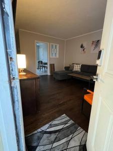a living room with a couch and a table at Modern & Cozy 2 bedroom home near downtown Shawnee in Shawnee +10 photos