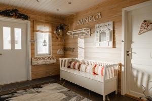 ein Kinderzimmer mit Holzwänden und ein Kinderbett mit Kissen in der Unterkunft Arcticmint in Rovaniemi