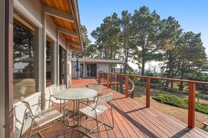 a patio with a table and chairs on a deck at Rosemary's Retreat in Mendocino