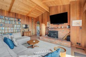 a living room with a couch and a fireplace at Rosemary's Retreat in Mendocino