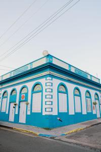 a blue and white building on the side of a street at CITY RETRO GUAYAMA in Guayama