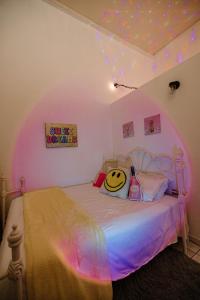 a bedroom with a hello kitty pillow on a bed at CITY RETRO GUAYAMA in Guayama