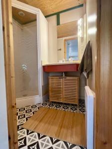 a small bathroom with a sink and a shower at Cosy Chalet au cœur du Sidobre avec Piscine et Spa in Vabre