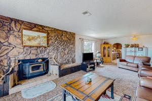 a living room with a stone wall at Western Wonders in Alamosa