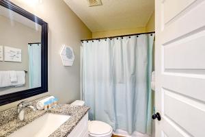 a bathroom with a shower and a sink and a toilet at Ocean's Shimmer Sanctuary in Panama City +13 photos