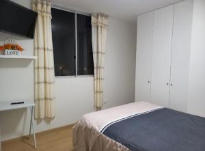 Ένα ή περισσότερα κρεβάτια σε δωμάτιο στο lindo departamento Frente al mar +11 φωτογραφίες