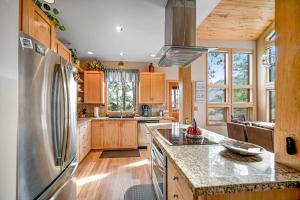 a kitchen with wooden cabinets and a stainless steel refrigerator at Top of the Mesa in Durango