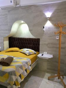 a bedroom with a bed with a cross on the wall at MAHDIA BORJ ERRAS (CAP AFRICA) in Mahdia