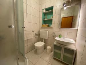 a bathroom with a toilet and a sink at Apartments Zeljko in Lumbarda +38 photos