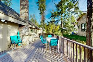 a deck with chairs and a table on a house at Cabin On The Lake in Harrison