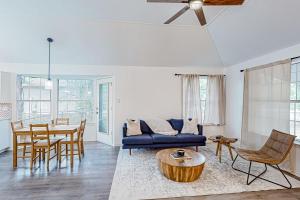 a living room with a blue couch and a table at Happy Daze Home in Buda