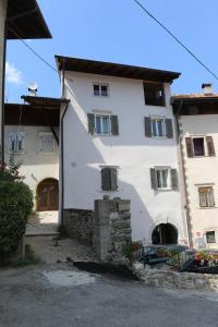 a large white building with windows and a door at Agriturismo La Ciasa Del Fabio in Tassullo