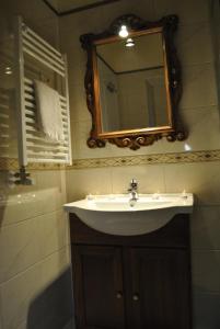 a bathroom with a sink and a mirror at Apartment Pod Kostanji in Osp