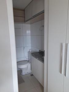 a bathroom with a white toilet in a room at Studio Iracema 2001 in Fortaleza
