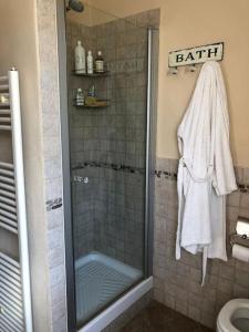 a bathroom with a shower with a towel and a sink at Ca' Cuore in Monferrato in Serralunga di Crea