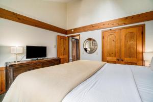 a bedroom with a large bed and a flat screen tv at Pinehurst Paradise A in Thompsonville