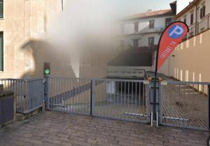 a fence with a street sign in front of a building at Soggiorno Michelangelo in Florence