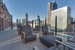 a balcony with chairs and a view of a city at Drury Plaza St. Louis at the Arch in Saint Louis