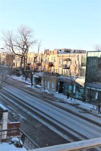 an empty street in a city with buildings at AAA Location - Bright and Cozy Apartment in Montréal