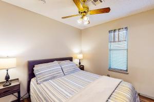 a bedroom with a bed and a ceiling fan at Casa de Cowboy in Stillwater