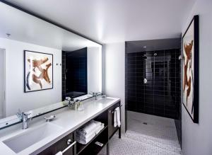 a bathroom with a large sink and a shower at Hotel Eastlund - Best Western Premier Collection in Portland