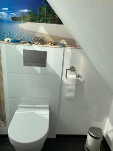 a bathroom with a toilet and a view of the ocean at Dachwohnung Nähe Clemenshospital in Münster
