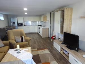 a living room with a couch and a tv in it at family friendly apartment 3 adults plus child in Ružomberok