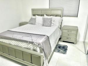 a bedroom with a bed and a nightstand next to it at New Air VACATION FUN in Pompano Beach