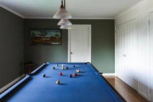 a pool table with balls on it in a room at Hey Little Joe - Cosy Retreat with Mountain Views in Warburton