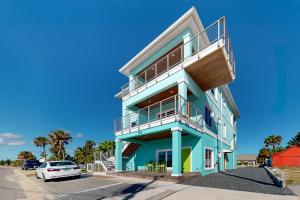 a blue and white building with a balcony at Salty Waves 1 in Flagler Beach
