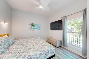 a bedroom with a bed and a large window at Salty Waves 1 in Flagler Beach