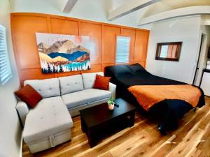a living room with a couch and a bed at Sand Hollow Zion Mini Home - Pets Welcome 2 with a Fee in Hurricane