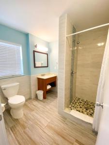 a bathroom with a toilet and a shower at Seahorse Oceanfront Inn in Neptune Beach