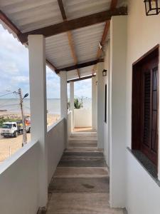 a hallway of a house with a view of the beach at Pousada Lua Branca in Tutóia
