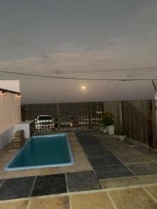 a swimming pool in the middle of a patio at Pousada Lua Branca in Tutóia