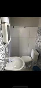 a bathroom with a sink and a toilet at Pousada Lua Branca in Tutóia