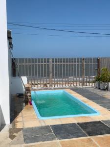 a swimming pool under an awning on a patio at Pousada Lua Branca in Tutóia