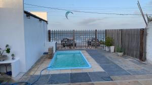 a small swimming pool in a backyard with a fence at Pousada Lua Branca in Tutóia