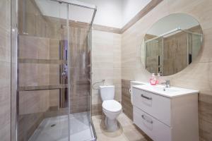 a bathroom with a shower and a toilet and a sink at 70s Hostel in Kraków