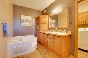 a bathroom with a tub and a sink at Spacious Canyon Ferry Lake House with Bar and Views! in Helena +35 photos