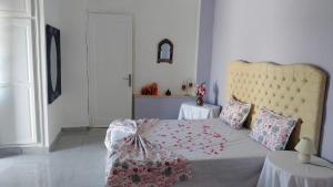 a bedroom with a large bed with a large headboard at Henchir ejdoud in Kairouan