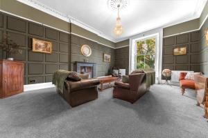 a living room with two chairs and a fireplace at 8 Corkickle in Whitehaven