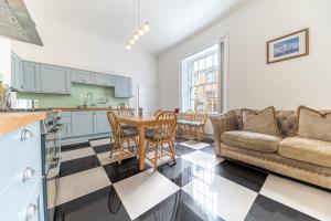 a kitchen and living room with a couch and a table at 8 Corkickle in Whitehaven