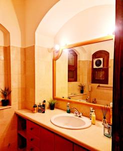 a bathroom with a sink and a large mirror at West golf 2bedroom in Hurghada