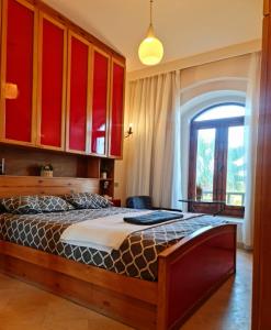 a bedroom with a large bed with red cabinets at West golf 2bedroom in Hurghada