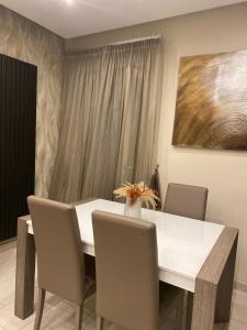a dining room with a white table and chairs at La Dimora di Antonella in Naples