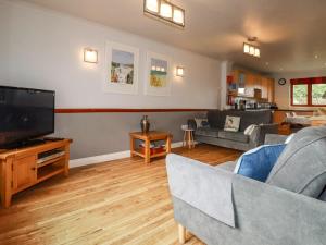 a living room with a couch and a tv at Sunflower Cottage in Wadebridge