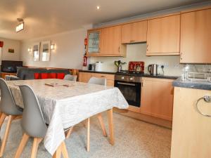 a kitchen and dining room with a table and chairs at Sunflower Cottage in Wadebridge
